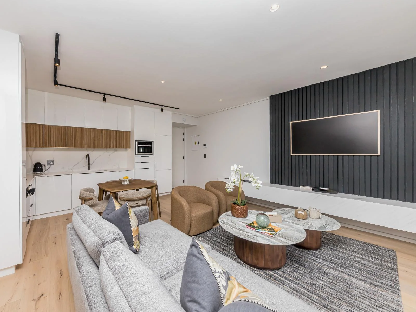 Open-plan lounge, dining area and fitted kitchen in apartment A010 at Aan de Meul