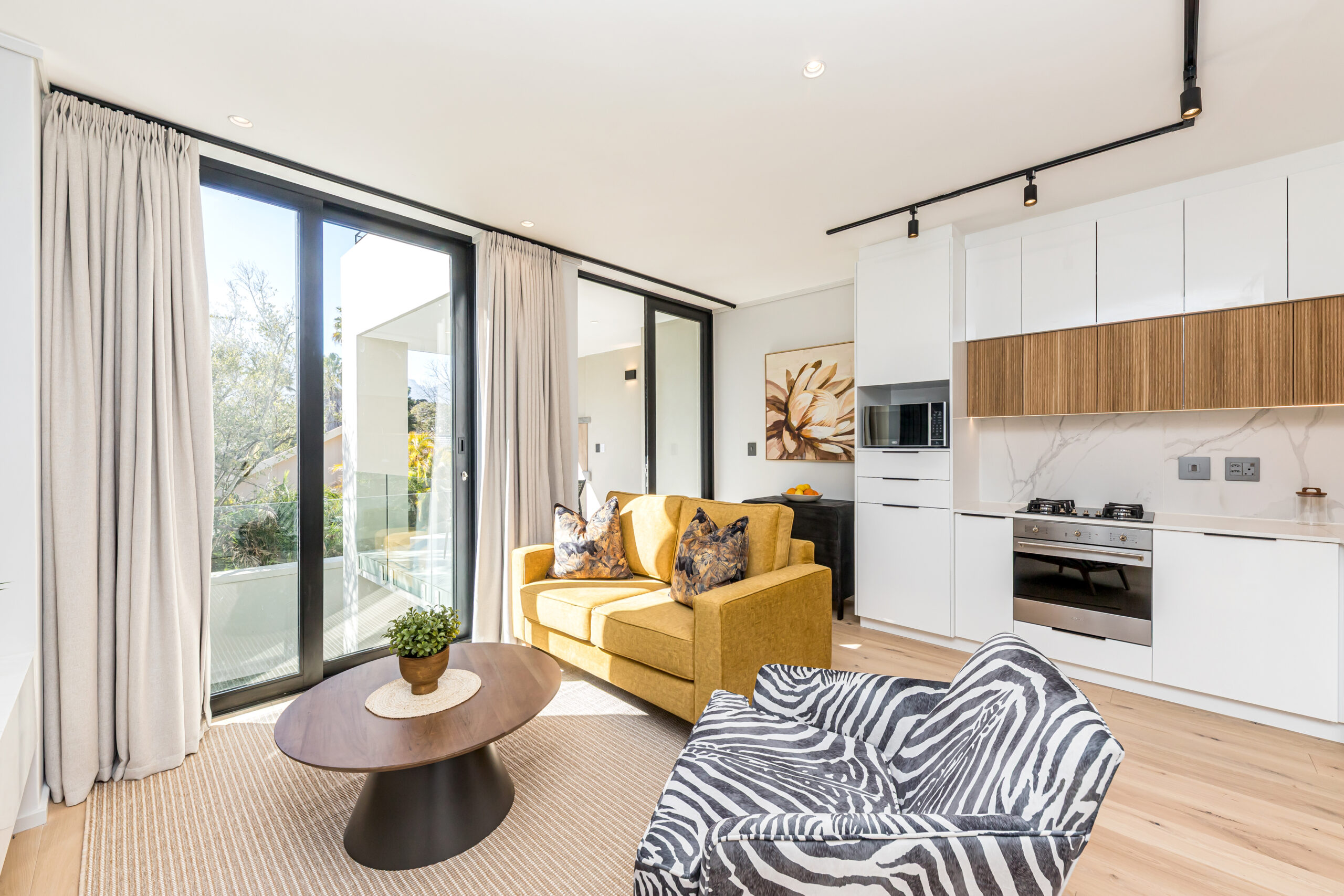 Bright lounge with balcony doors in a Luxury one-bedroom apartment at Aan de Meul