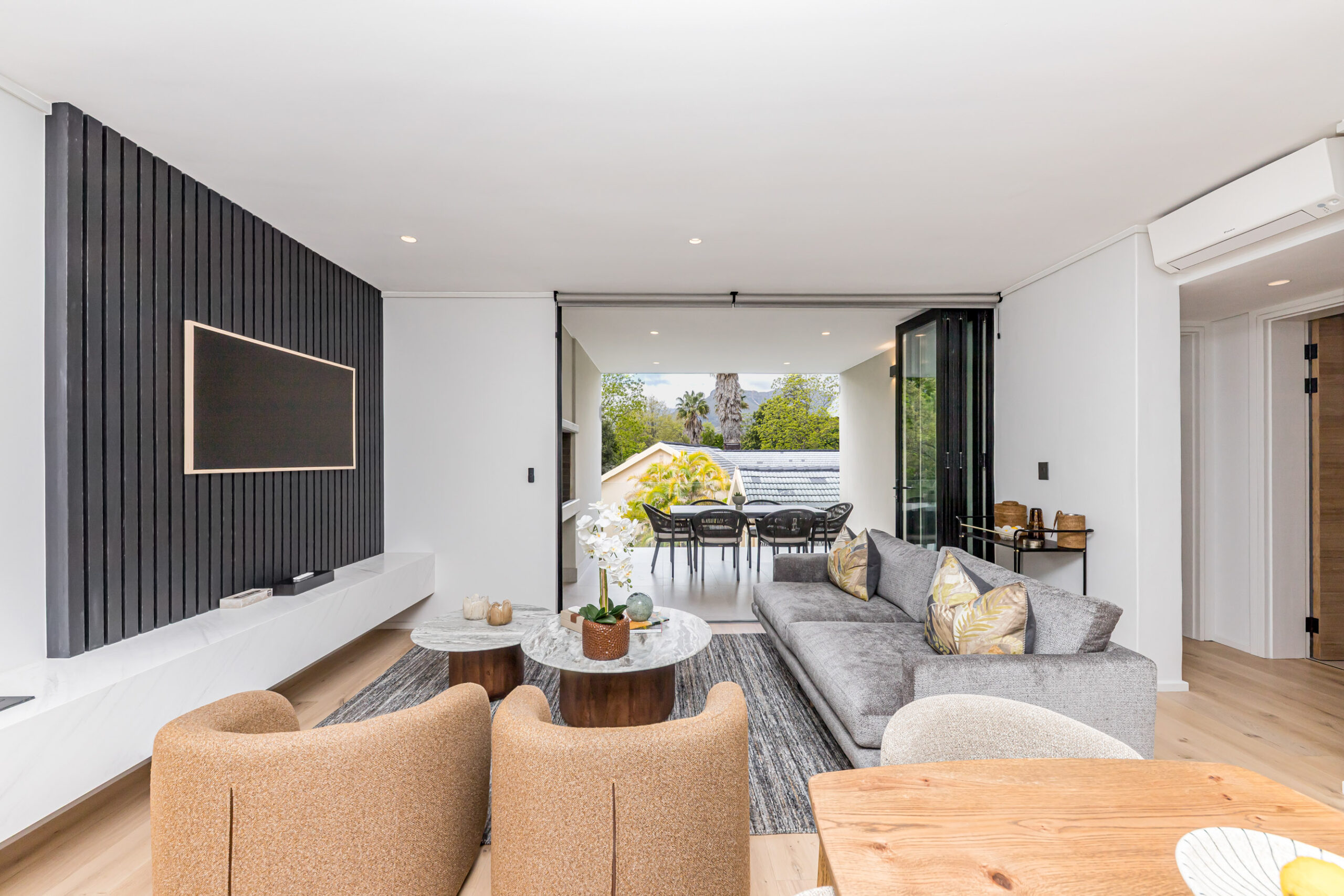 Open-plan lounge and outdoor dining in a Two-bedroom balcony apartment at Aan de Meul