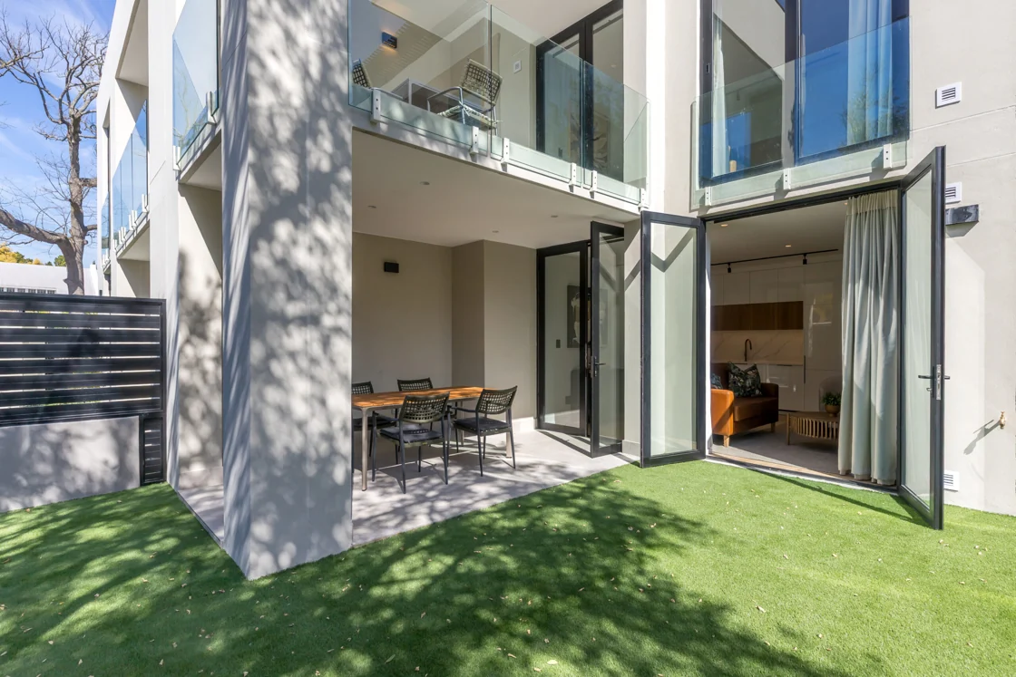Private lawn and covered outdoor dining area beside the ground-floor apartment in the Superior One Bedroom apartment at Aan de Meul