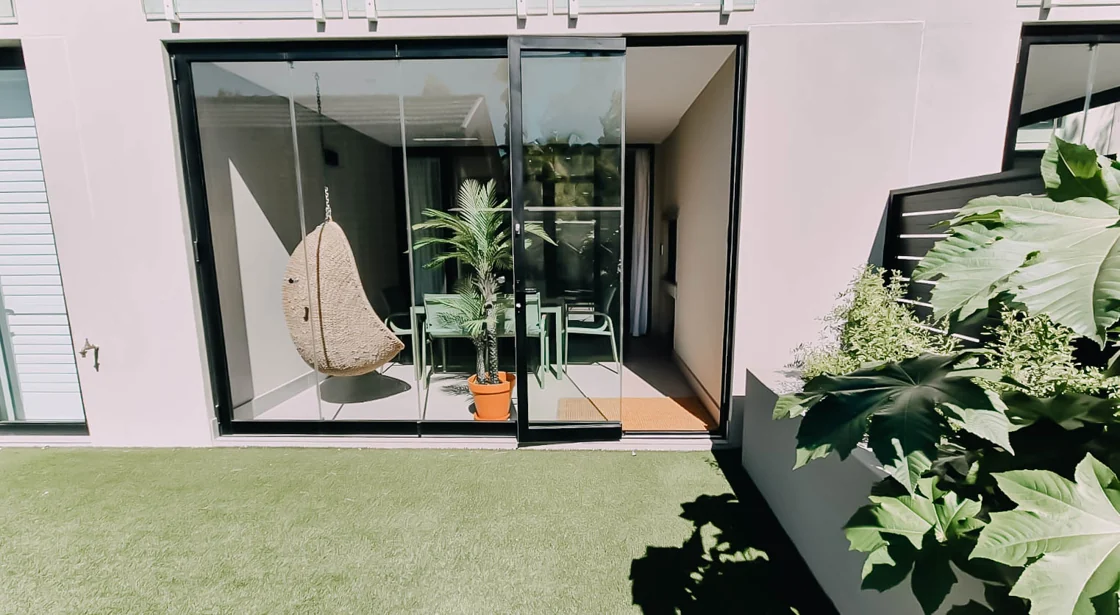Private garden and hanging patio chair at apartment A005, Aan de Meul